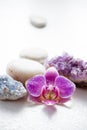 One pink orchid blossom with zen stones and amethyst cluster and blue cluster crystal.
