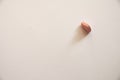 One pink pill in the form of a heart lies on its side alone on a white background Royalty Free Stock Photo