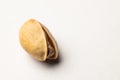 One pistachio nut on a white background, close-up Royalty Free Stock Photo