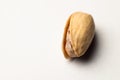 One pistachio nut on a white background, close-up Royalty Free Stock Photo