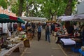 Vanves flea market on early Saturday morning with vendor setting up stalls in Paris, France