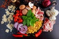One pot pan pasta with bacon, chestnut mushrooms, cherry tomatoes, red onion, conchiglie and basil leaves Royalty Free Stock Photo