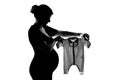 One pregnant woman holding baby clothes Royalty Free Stock Photo