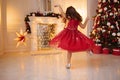 One pretty little girl with blonde hair wearing red, sparkly Christmas dress Royalty Free Stock Photo