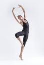 One Professional Male Ballet Dancer Young Man in Black Dance Tights Suit Posing in Ballanced Dance Pose With Lifted Hands in