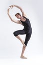 One Professional Male Ballet Dancer Young Man in Black Dance Tights Suit Posing in Ballanced Dance Pose in Studio