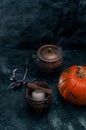 One pumpkin squash and copper or brass witch pots with candles Royalty Free Stock Photo