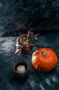 One pumpkin squash and copper or brass witch pots with candles Royalty Free Stock Photo