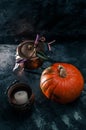 One pumpkin squash and copper or brass witch pots with candles Royalty Free Stock Photo