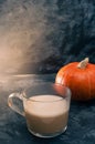 One pumpkin squash and a latte coffee made with with plant based oat soya or almond milk  with blank notepad notebook at the table Royalty Free Stock Photo