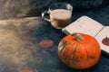 One pumpkin squash and a latte coffee made with with plant based oat soya or almond milk  with blank notepad notebook at the table Royalty Free Stock Photo