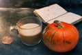 One pumpkin squash and a latte coffee made with with plant based oat soya or almond milk  with blank notepad notebook at the table Royalty Free Stock Photo