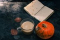 One pumpkin squash and a latte coffee made with with plant based oat soya or almond milk  with blank notepad notebook at the table Royalty Free Stock Photo