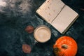 One pumpkin squash and a latte coffee made with with plant based oat soya or almond milk  with blank notepad notebook at the table Royalty Free Stock Photo