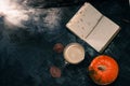 One pumpkin squash and a latte coffee made with with plant based oat soya or almond milk  with blank notepad notebook at the table Royalty Free Stock Photo