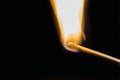 One quiet burning match on black background. Royalty Free Stock Photo