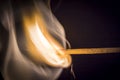 One quiet burning match on black background. Royalty Free Stock Photo