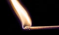 One quiet burning match on black background. Royalty Free Stock Photo