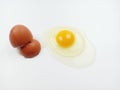 One raw chicken egg with yellow yolk and clear white egg in three layers and broken eggshell in pieces isolated on white