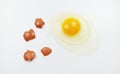 One raw chicken egg with yellow yolk and clear white egg in three layers and broken eggshell in pieces isolated on white