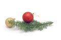 One red ball on Christmas tree branch and more golden ball isolated on white background. Royalty Free Stock Photo