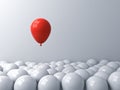 One red balloon pop out from the white balloons Stand out from the crowd different concept or think outside the box