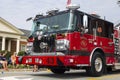 One red and black fire engine truck driving through the fourth of July parade