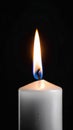 One red candle burns on a dark background. Memory, memorial, romance, prayer, religion. Vertical banner.