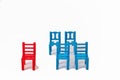 one red chair is standing outside of a group of blue chairs. difference, loneliness and individuality concept Royalty Free Stock Photo