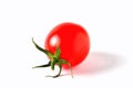 One red cherry tomato with green leaves on a white background, i Royalty Free Stock Photo