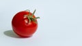 One red cherry tomato with green stems on a white background.copyspace for text Royalty Free Stock Photo