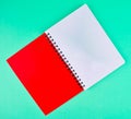 One red colored note paper diary placed on a light blue paper background Royalty Free Stock Photo