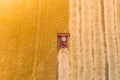 One red combine harvest wheat in the field. Top view. Royalty Free Stock Photo