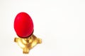 One red easter egg in candleholder on light background Royalty Free Stock Photo