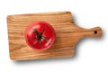 One red and fresh raw tomato in the middle of a wooden cutting board isolated on a white background. concept of healthy vegan Royalty Free Stock Photo