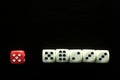 One Red game dice and five white game dice Royalty Free Stock Photo