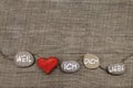 One red heart with stones on wooden background. Greeting card fo Royalty Free Stock Photo