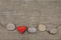 One red heart with stones on wooden background. Royalty Free Stock Photo