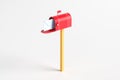 One red mailbox with an envelope inside on a white background Royalty Free Stock Photo