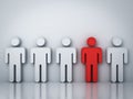 One red man standing among white people on gray background Royalty Free Stock Photo