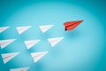 One red paper plane pointing in different way on blue background. Business for new ideas creativity and innovative solution Royalty Free Stock Photo