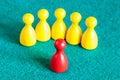 One red pawn in front of several yellow pawns