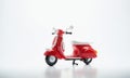 One red plastic scooter on a white background, a toy Royalty Free Stock Photo