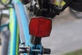 One red plastic warning light on a black blue sports bike