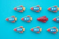 One red rocket different from other on blue background. Think differently, standing out from the crowd, creative thinking ideas