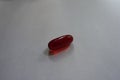 One red capsule of krill oil Royalty Free Stock Photo