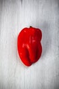 One red sweet pepper on white table