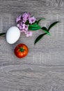 one red tomato and one egg, violet, objective photography