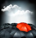 One red umbrella in a group of grey umbrellas. Royalty Free Stock Photo