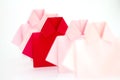 One Red among white origami shirt paper , unique individuality a